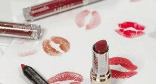 Mirabella Beauty Gluten-free lipsticks & lip glosses displayed with swatch kisses on paper, showcasing vibrant, long-lasting color options on a white