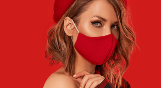 Mirabella Beauty Mask Model on red background wearing pretty eye makeup