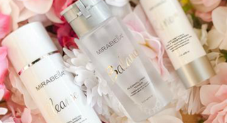 Mirabella skincare products including Cleanser, alcohol free Toner, & Renew Moisturizer displayed on flowers, for gluten free skincare