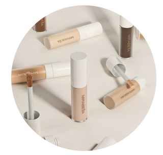 Mirabella Perfecting Concealers: sleek tubes with various shades for flawless coverage & blemish concealment - precise doe-foot applicator.