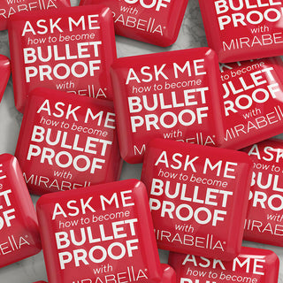 Group of Bulletproof Button Pins featuring a sleek design, polished finish, and 'Ask me how to become Bulletproof with Mirabella' message.