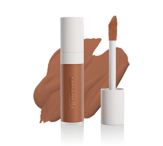 Mirabella Perfecting Liquid Concealer tube with doe-foot applicator and swatch in Deep D210, showcasing sleek design & precise application.