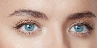 Close-up of Mirabella model showing a before of eyebrows before using the Pro Sculpt Clear Brow Gel.